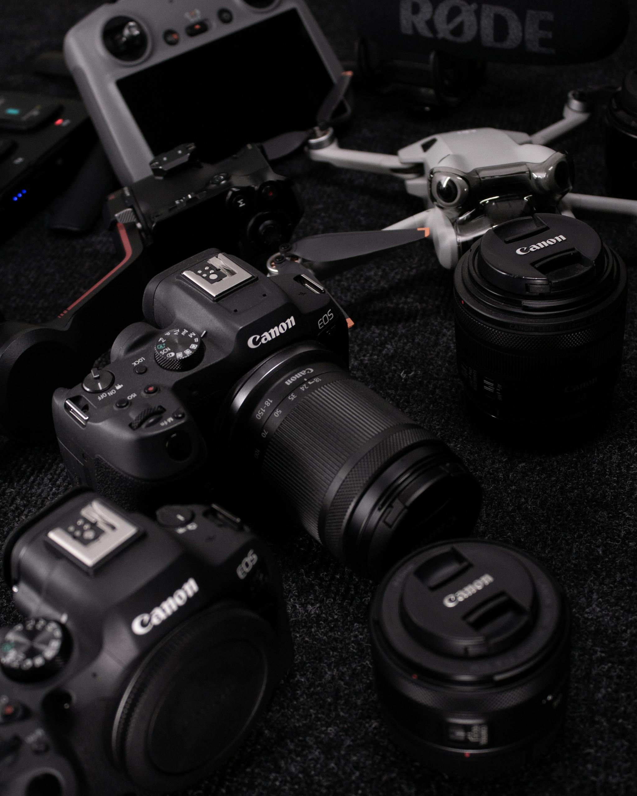 A collection of professional photography gear including cameras, lenses, and drones captured in a studio setting.